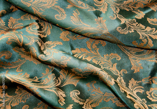 Canvastavla Detailed teal and gold damask fabric pattern with intricate woven textures ornam