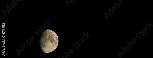 Obraz na plátně Detailed moon with negative space against a black night sky