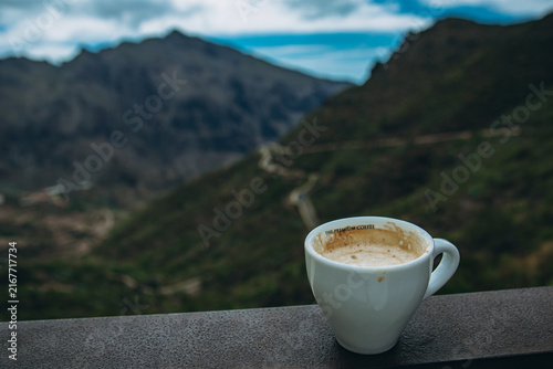 Bild auf Leinwand Enjoying a cup of coffee with a serene mountain view