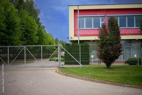 Closed metal gate at the entrance to a modern commercial building