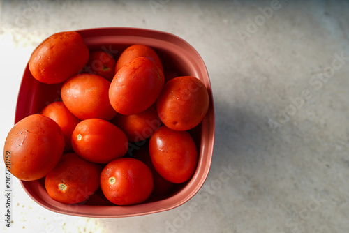 Red plum tomatoes in a bowl ready for cooking