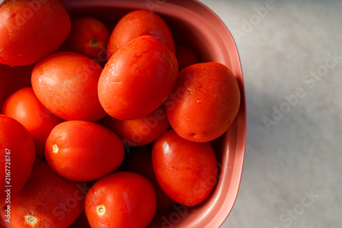 Fresh plum tomatoes filling a bowl, ready for cooking