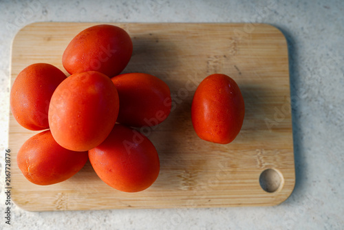 Fresh red tomatoes on wooden cutting board