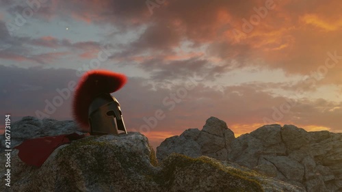 3D Animation of an ancient greek Sparta helmet with red cape laying on rocks in the evening sunset