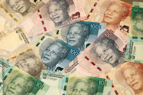 South African rand money bills in pile on table. South Africa ZAR currency cash close up