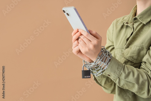 Принти на полотні Smartphone addiction and digital detox concept, persons hands chained to a mobil