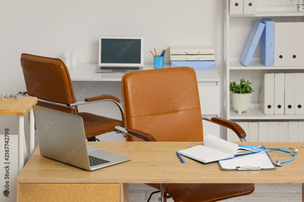 Fototapeta premium Doctors workplace with laptop and clipboards in medical office