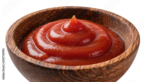 Konstfotografi Rich red tomato ketchup swirled in a rustic wooden bowl, isolated on transparent