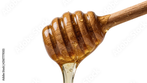 Fotografía Wooden honey dipper with dripping golden honey, isolated on transparent backgrou