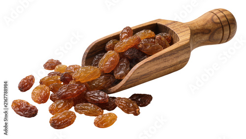 Dried golden raisins spilling from a wooden scoop, isolated on transparent background