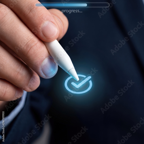 Person touching digital checkmark icon on touchscreen device
