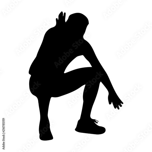 Silhouette of a Person in a Squatting Pose.