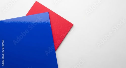 Minimalist abstract composition featuring overlapping royal blue and crimson red rectangles on a white backdrop with gloss and matte textures, composition, royal, clean