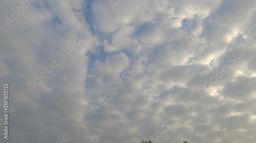Beautiful white fluffy stratocumulus clouds moving slowly across a blue sky. Natural heavenly background for weather forecast, sky replacement, and cinematic establishing shot.