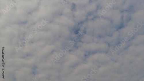 Dramatic dramatic cloudy sky with thick grey layers and sunlight filtering through. Natural weather background for meteorological and atmospheric concepts.