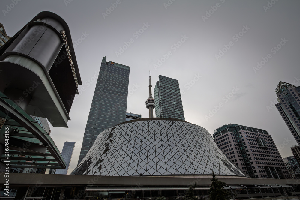 Fototapeta premium TORONTO, CANADA - DECEMBER 31, 2016: CN Tower rises among downtown Toronto skyscrapers showing Canada well known communications and observation tower within the city's modern skyline.