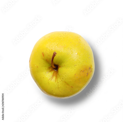 Fresh yellow apple casting soft shadow on white surface