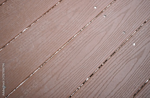 Принти на полотні Brown wooden deck planks with visible grain, aligned in parallel and secured by metal screws, with white residue between gaps