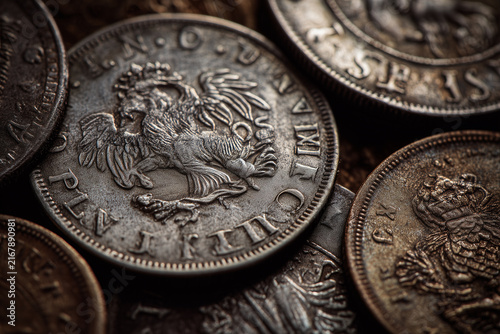 Antique silver coins featuring historical engravings and old patina