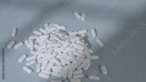 Pile Of Pills Medication On Blue Background