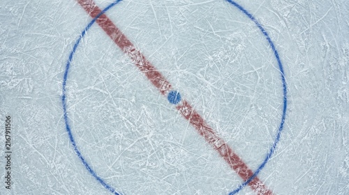Top Down View of Scratched Ice Surface on Hockey Rink with Red Line and Blue Face-off Circle