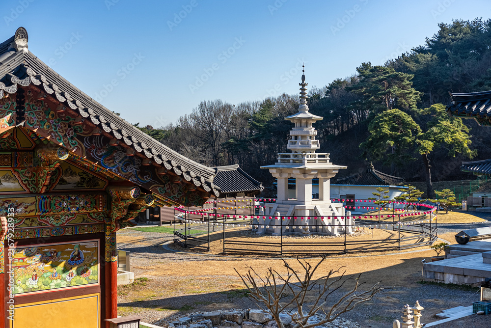 Obraz premium Stone pagoda surrounded by traditional Korean temple buildings at Ssanggyesa in Daebudo