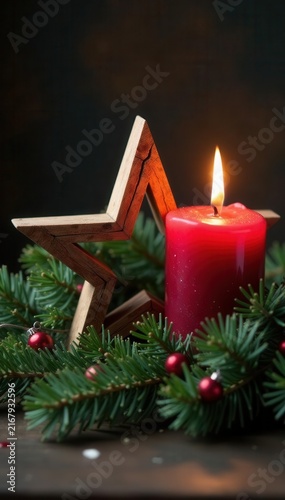 Rustic wooden star with burning candle, Xmas greenery, christmas eve, warm