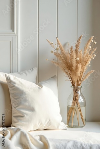 Subtle textures Creamy pillows, delicate dried flowers in glass vase, white wood backdrop , photography, minimalist, scandi