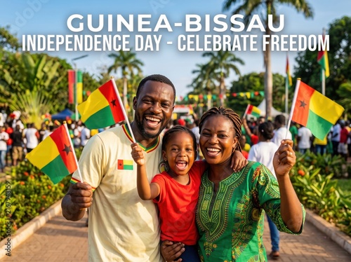 Happy african family holding guinea bissau flags outdoors during independence day celebration with palm trees and a crowd in the background under a bright sunny sky