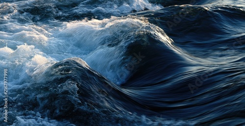 Dynamic ocean waves crash and churn with sunlight glinting on the turbulent surface