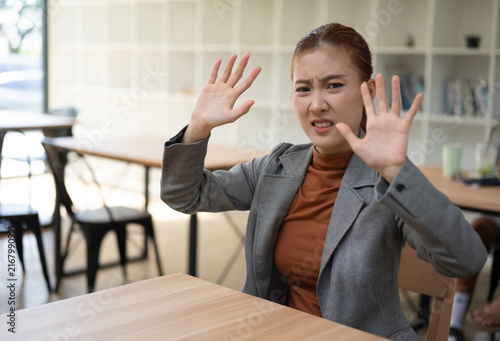 Asian Businesswoman Showing Disgusted Face Making Stop Gesture With Hands In Office