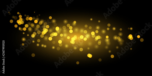 Abstract golden particles floating in dark space creating a magical and glowing light effect background design