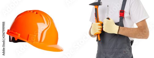 Young man holds tools in his hands with hard hat nearby, PNG