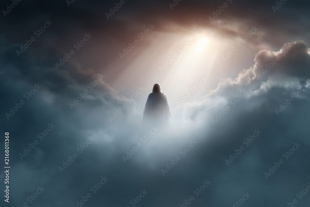 Obraz premium Silhouetted figure stands atop misty clouds. Radiant light breaks through dark, swirling skies. Mysterious presence evokes awe and reverence. Ideal for spiritual, religious, or inspirational themes