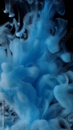 4K close-up footage of acrylic paint dispersion in liquid. Blue glittery steam rise