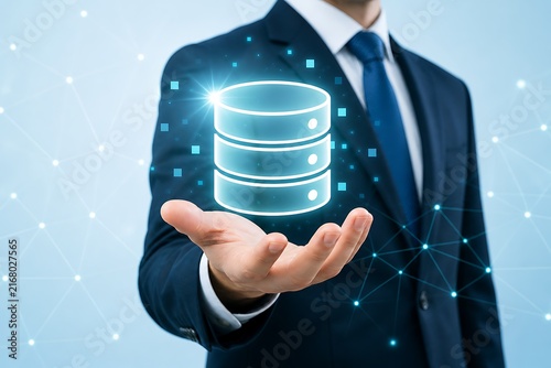 Businessman holding holographic database server with glowing digital icons