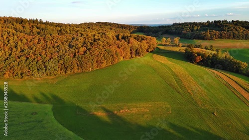 Golden Hour Aerial View of Rolling Autumn Fields and Forests