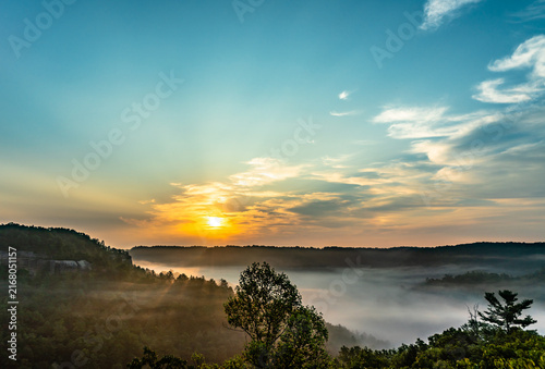 фотографія The sun rises above the misty valley of Red River Gorge in Daniel Boone National
