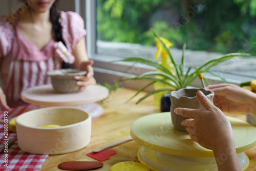 Canvastavla Two People Enjoying Pottery Clay Crafting Workshop Together at Wooden Table by W