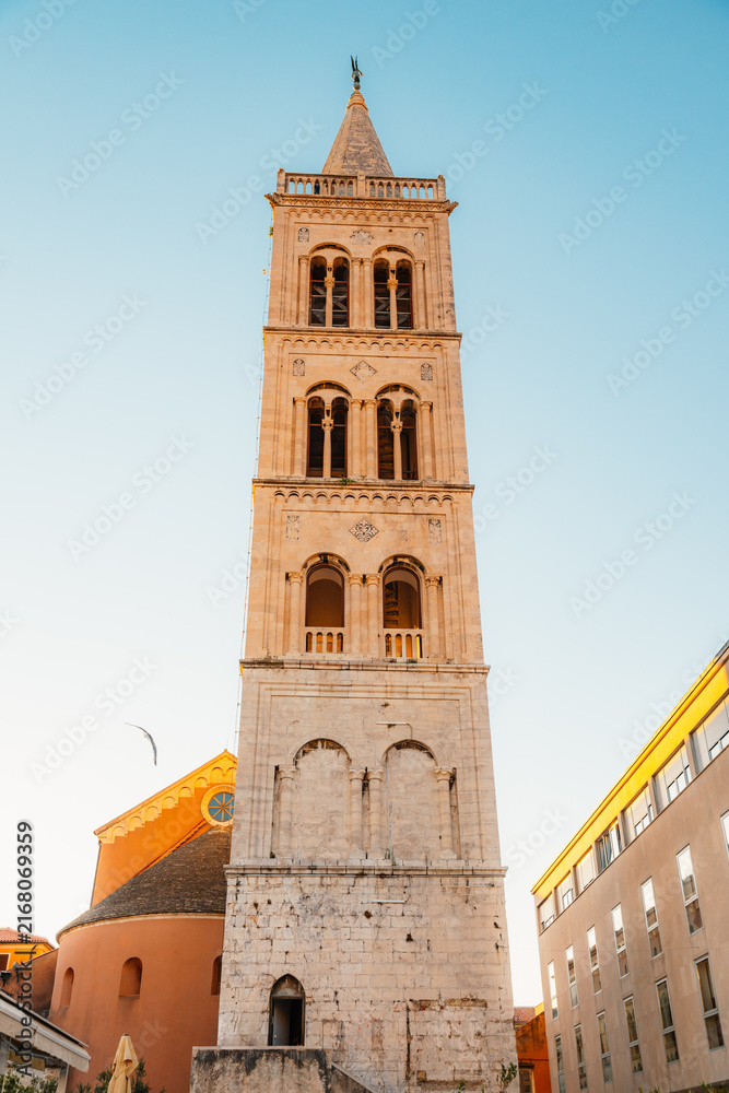 Fototapeta premium Zadar, Croatia. Old town street of Zadar with the Church of St. Donatus and the bell tower of the Cathedral of St. Anastasia at sunset.