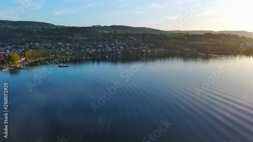 Scenic Aerial View of Lake Village Shoreline During Golden Hour Sunset