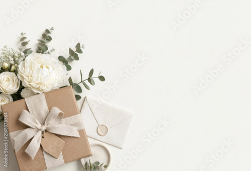 Gift box with white flowers and envelope isolated on white background