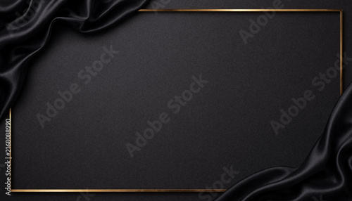 Luxury black silk fabric background with golden frame and copy space