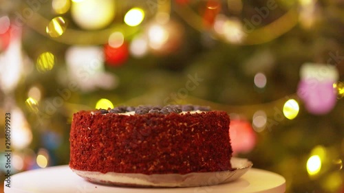 Festive Red Velvet Cake with Blueberries Against Bokeh Christmas Lights