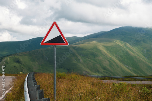 Warning road sign on mountain pass