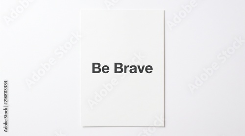 Be Brave motivational quote on a clean white background with simple graphic lines.