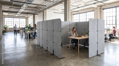 Modern open-plan office with acoustic dividers creating individual workspaces and promoting