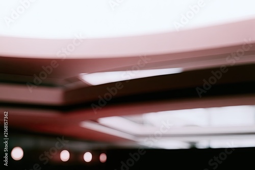 Curved architectural interior with soft lighting and subtle red accents