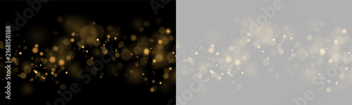 Фотография Scattered golden bokeh lights creating a soft glowing effect on a black backgrou