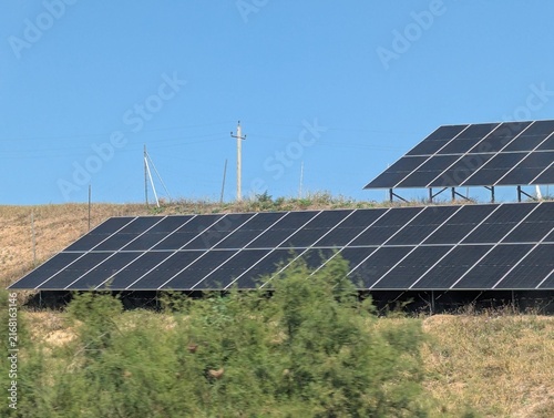 Принти на полотні A sprawling field of solar panels stretches across a sun-drenched hillside in the Georgian countryside, soaking up the intense summer rays